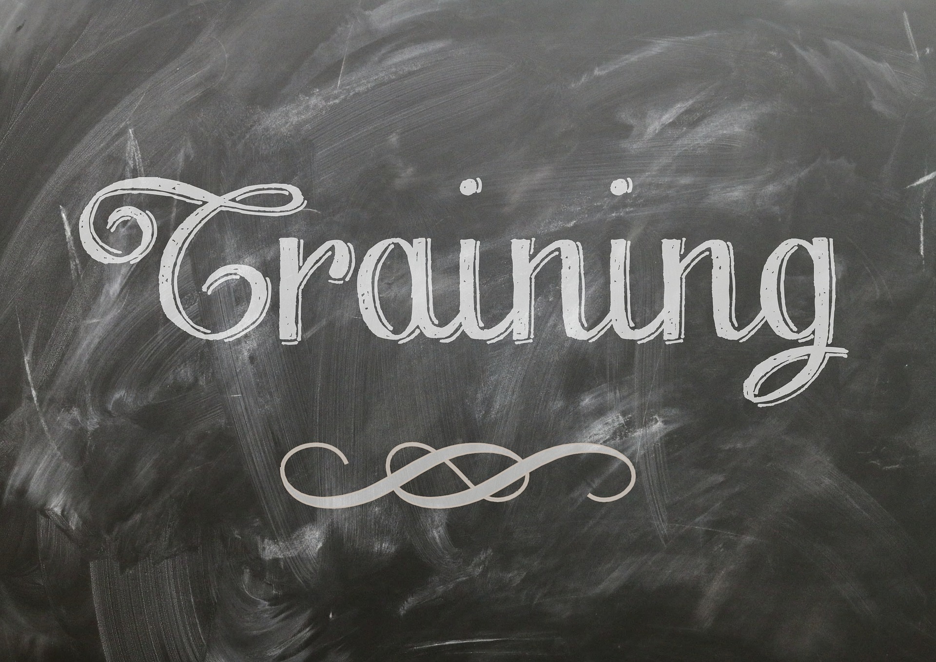 The word "Training" is written in white chalk on a blackboard.